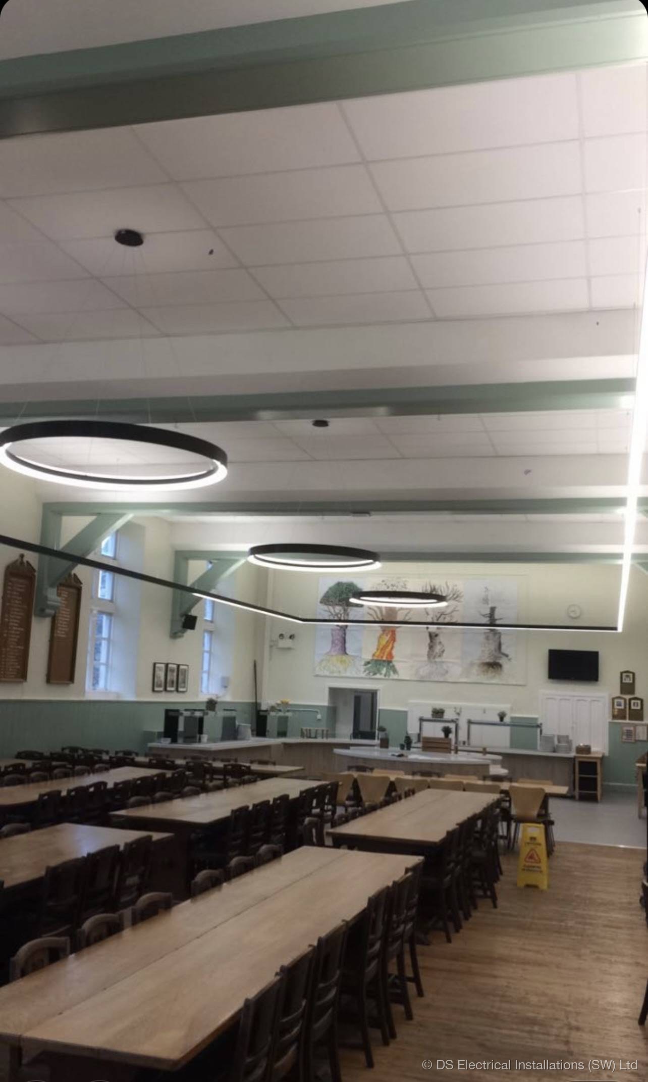 Heritage church nave lit with concealed warm-white LED uplighters along stone columns