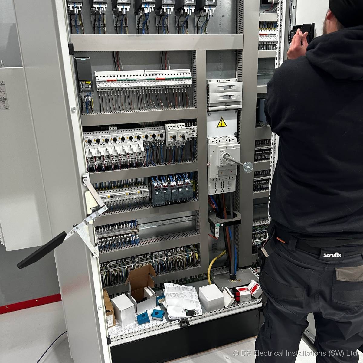 Three-phase commercial control panel with labelled MCBs and contactor stack