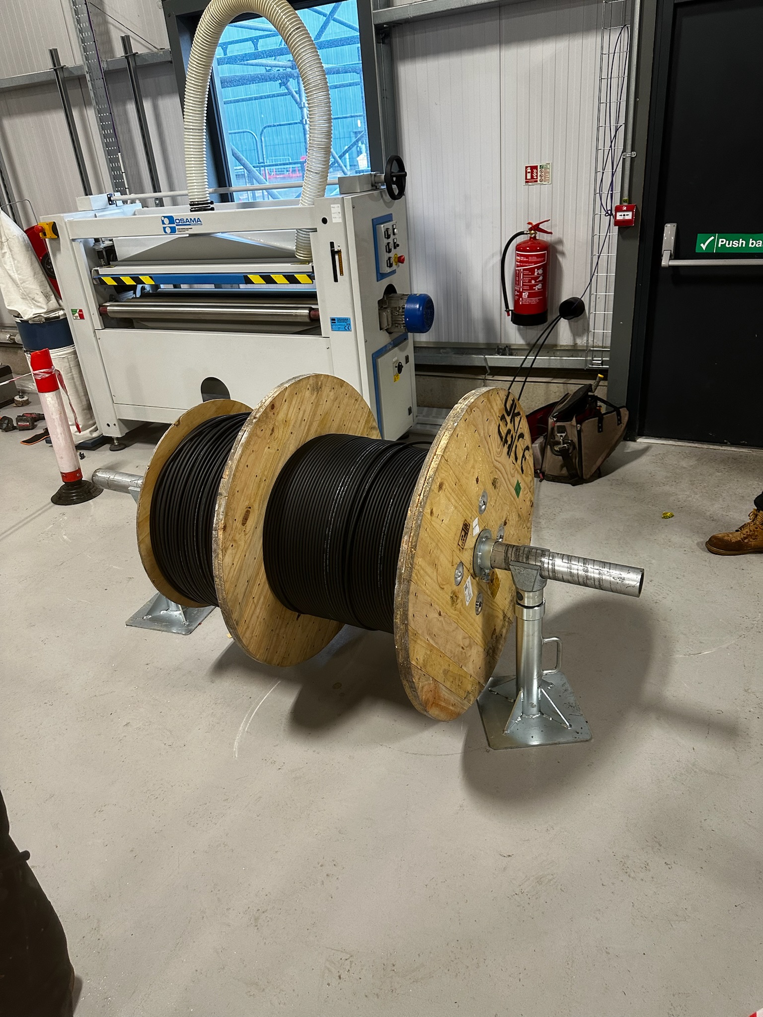 Data cable drum on roller jacks ready for pull — PoE structured cabling install by DS Electrical