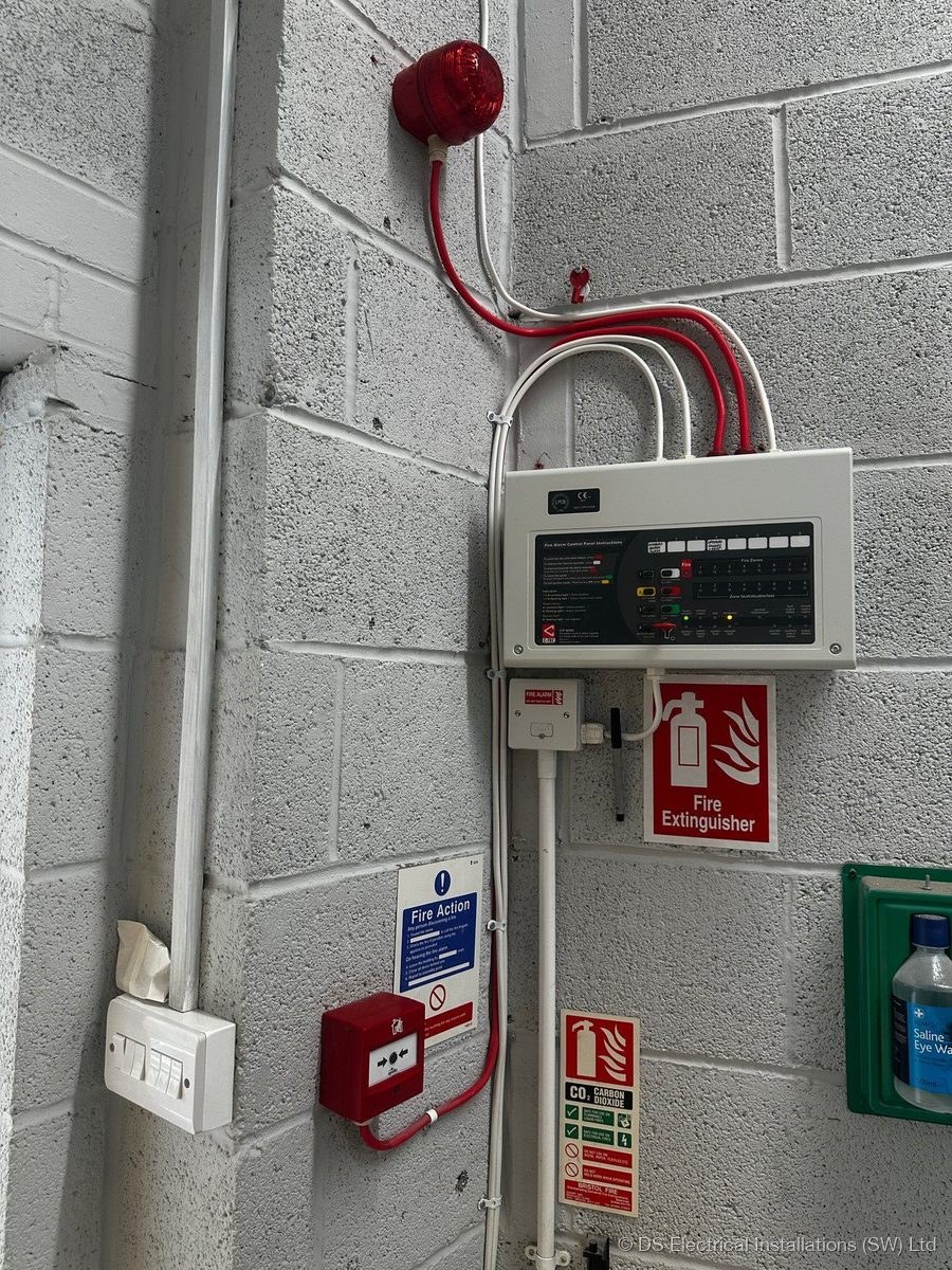 Commercial fire alarm system installed by DS Electrical with control panel, manual call point, sounder beacon and fire action signage