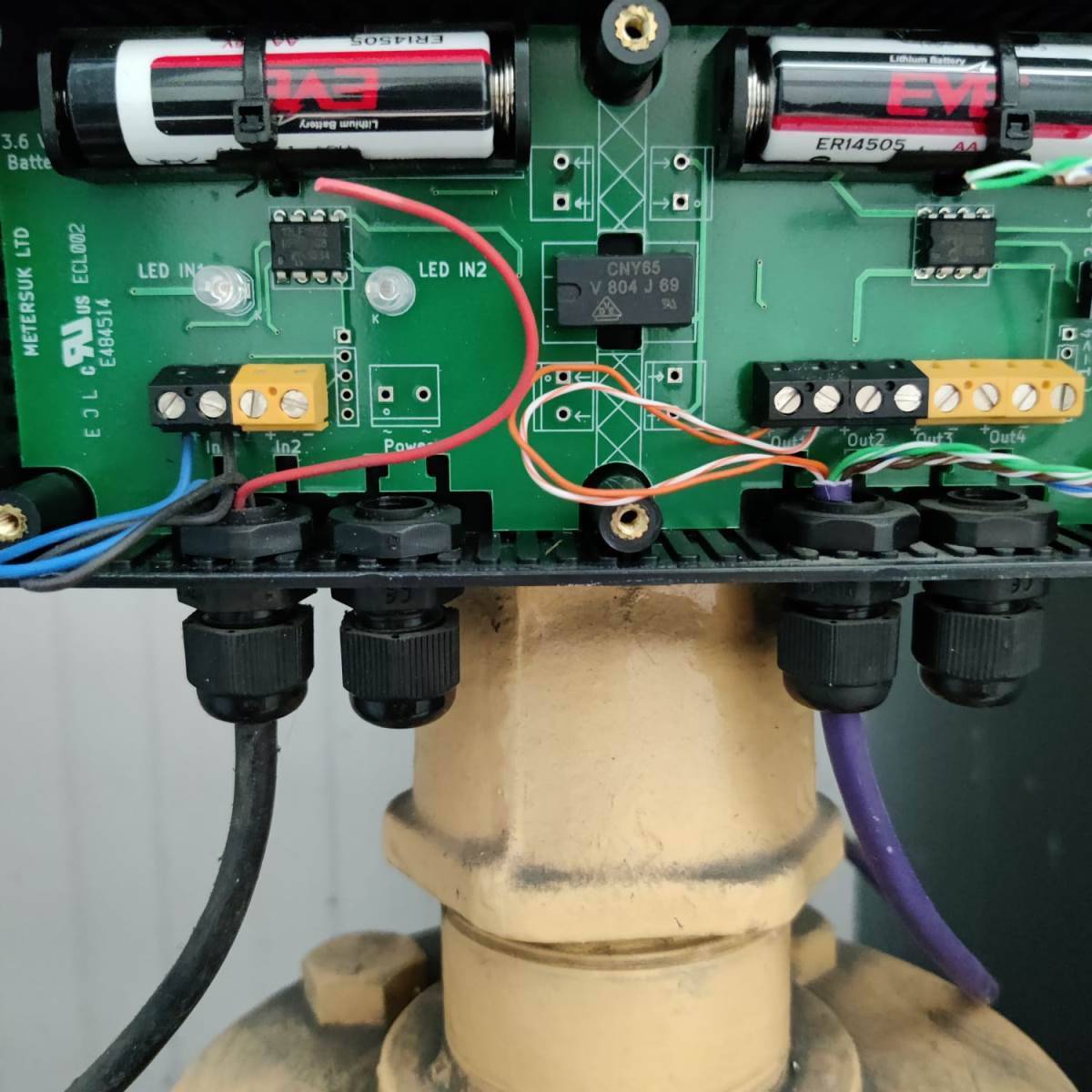 Fire alarm sounder base wiring opened up for inspection, terminations and cable connections to detector head