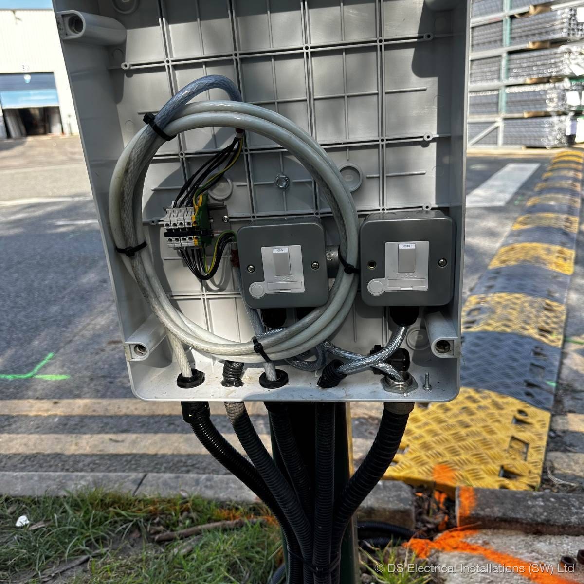 Outdoor weatherproof enclosure with twin switched fused connection units and SWA cable supplying site equipment