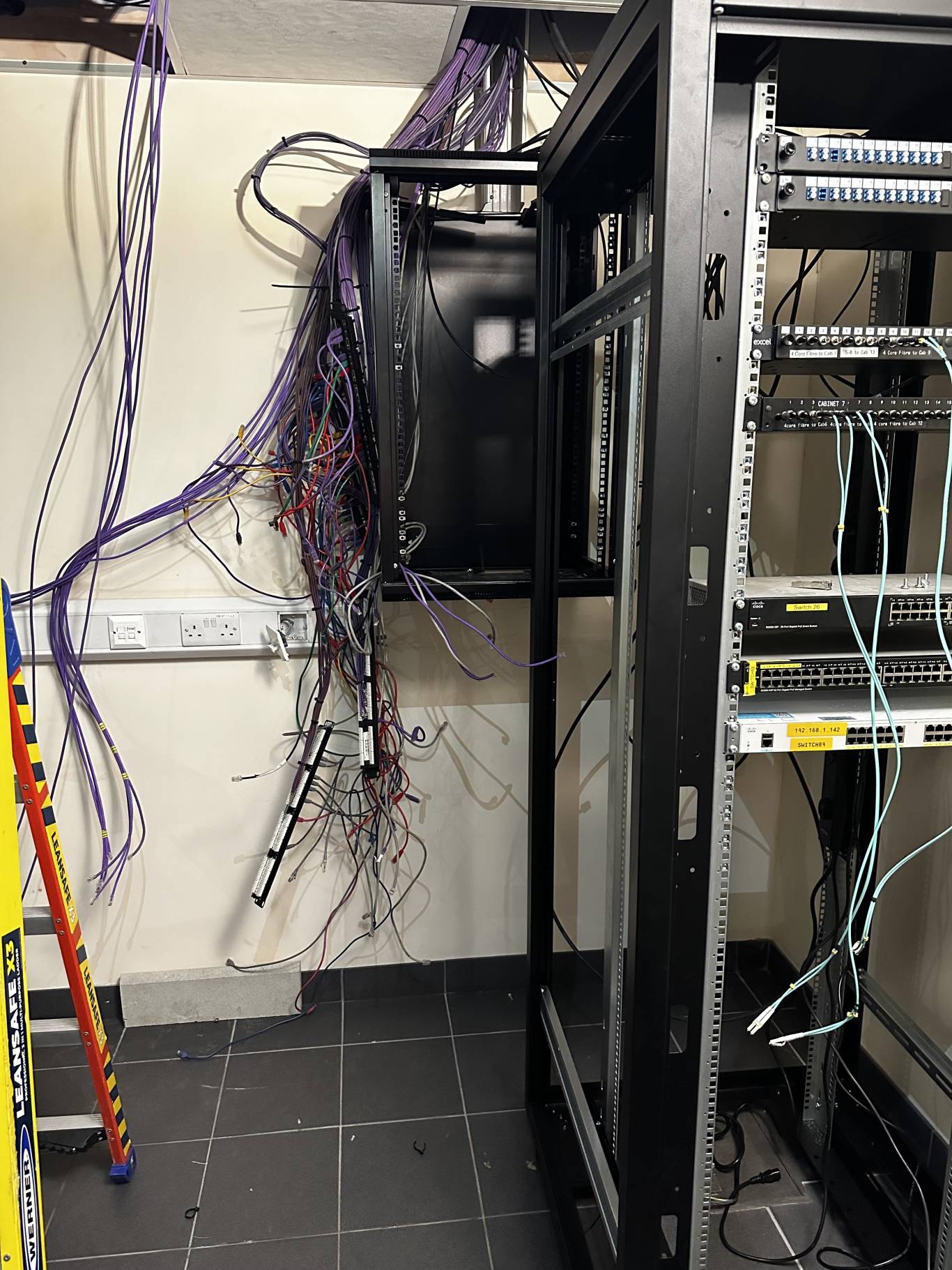 Two-storey commercial unit exterior with surface-mounted cable runs and floodlighting installed by DS Electrical