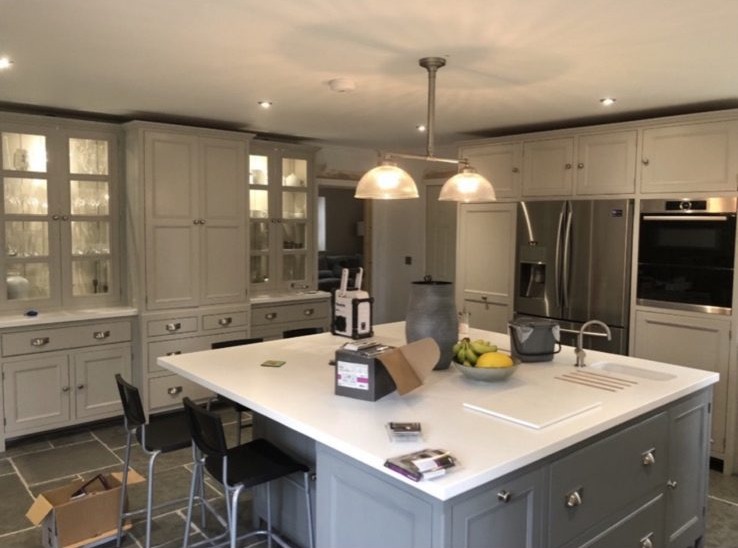 Traditional kitchen with twin glass pendants over a quartz island