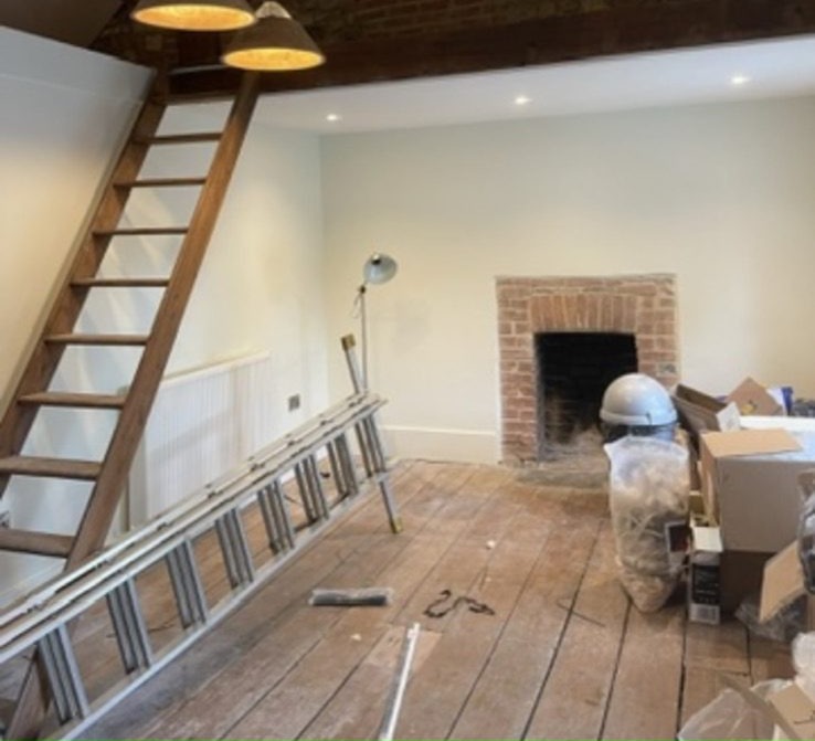 Heritage room with exposed beams and double pendant lighting