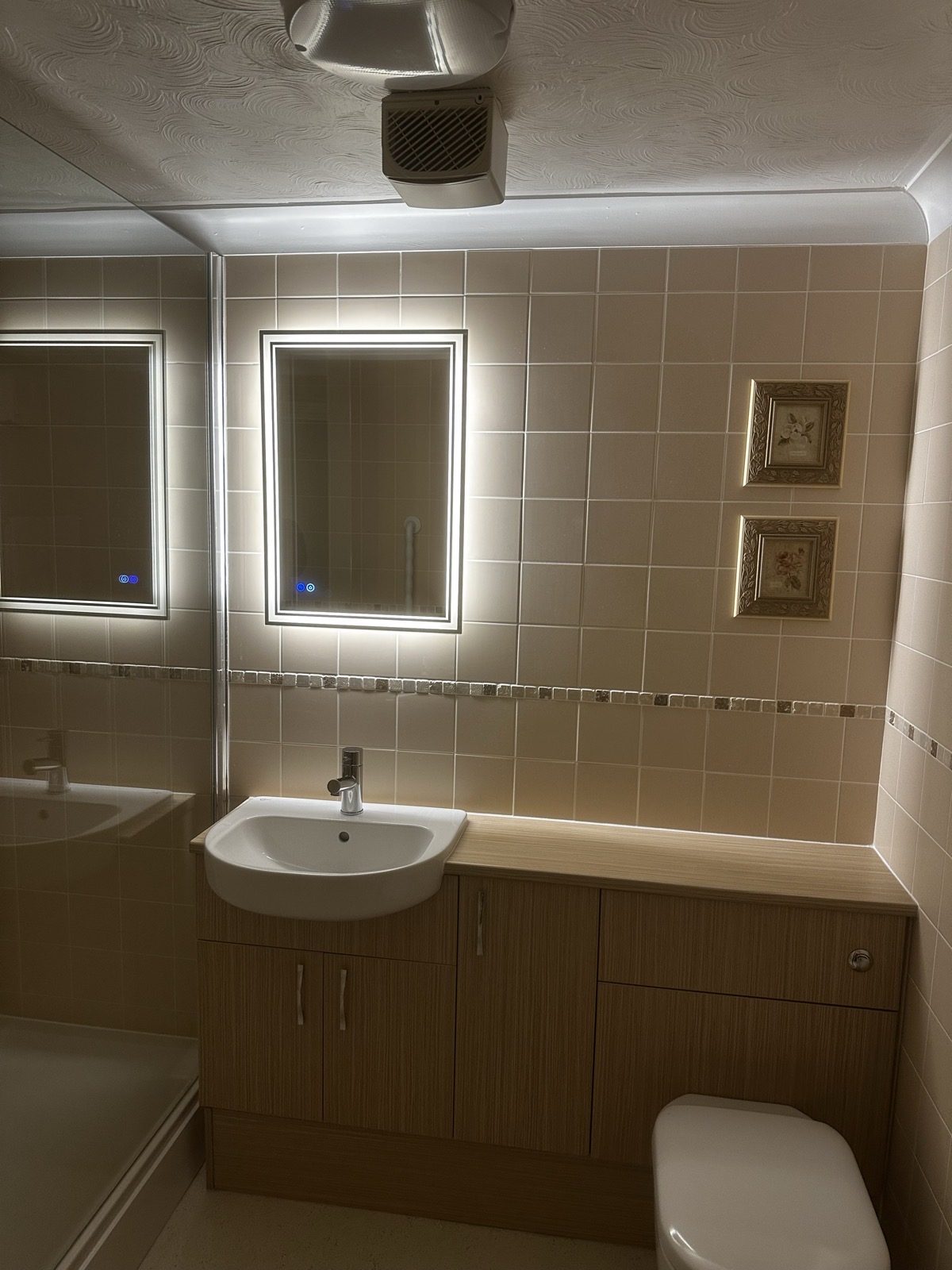 Commercial bathroom with LED mirror, urinal and downlights