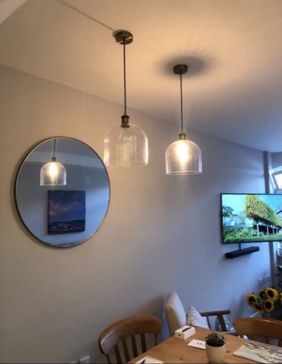 Glass pendant lights over dining table