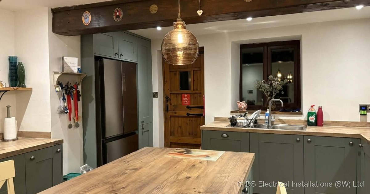 Open-plan kitchen-diner with even LED downlight wash from a 4x3 grid of fittings