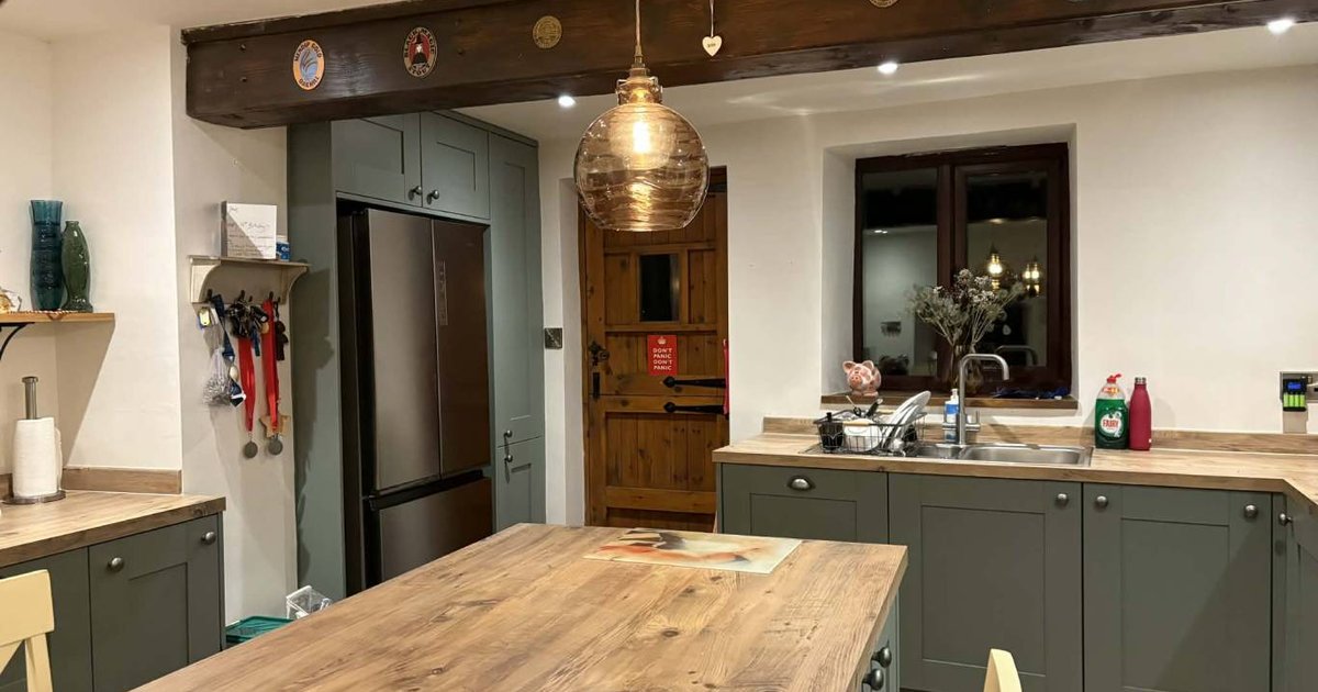 Open-plan kitchen-diner with even LED downlight wash from a 4x3 grid of fittings