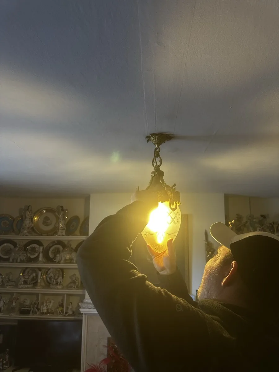 Wall light being carefully installed in period property