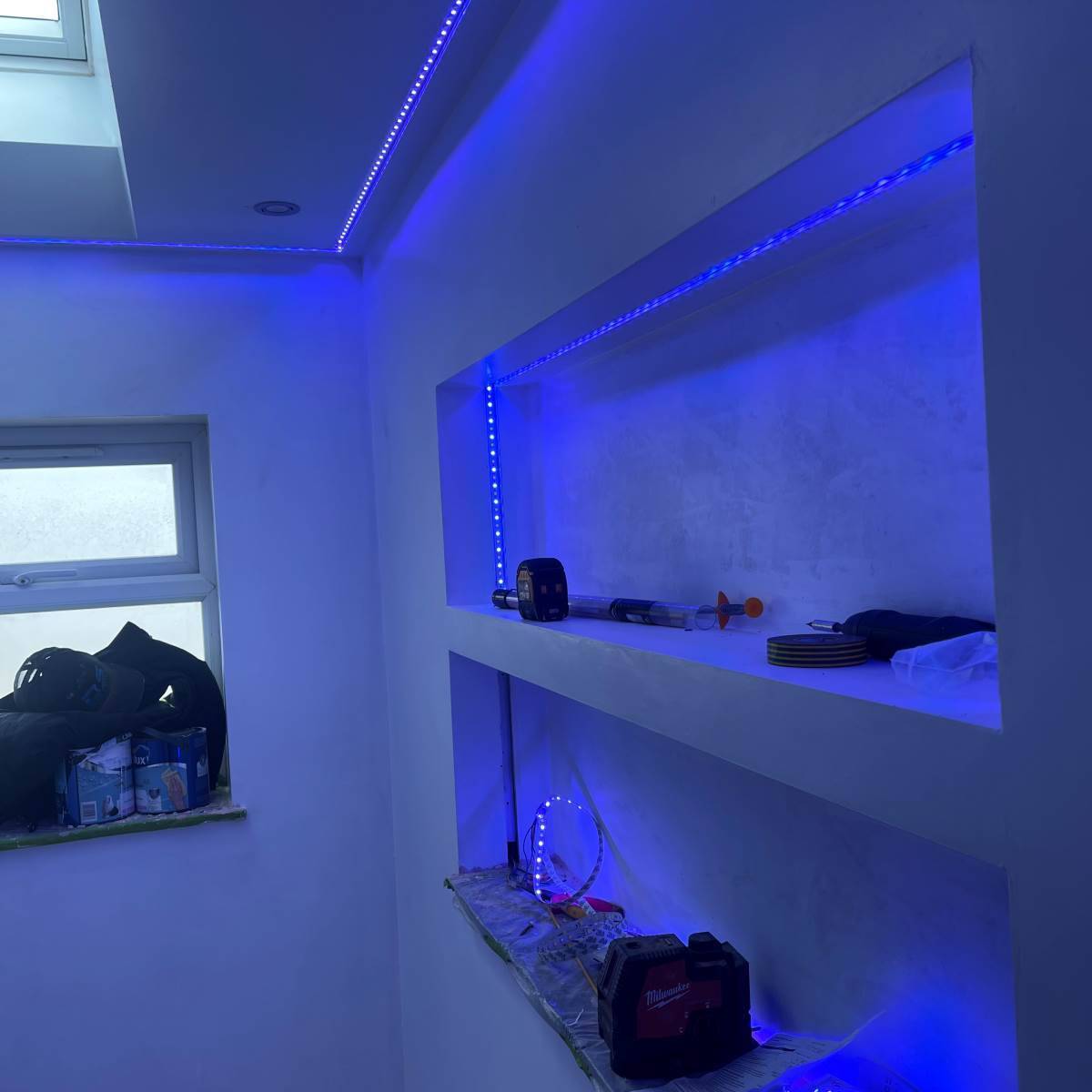 Warm-white LED strip lighting recessed into kitchen plinth and underside of wall units
