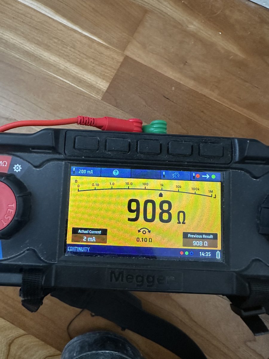 Megger MFT insulation tester reading 908 megohms during a portfolio EICR