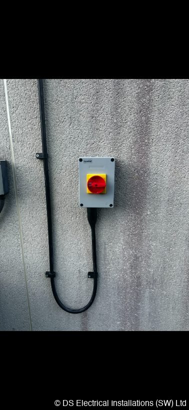 Outdoor rotary isolator fixed to a rendered wall