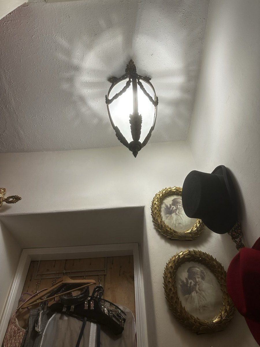 Period wall sconce installed at picture-rail height in the principal bedroom