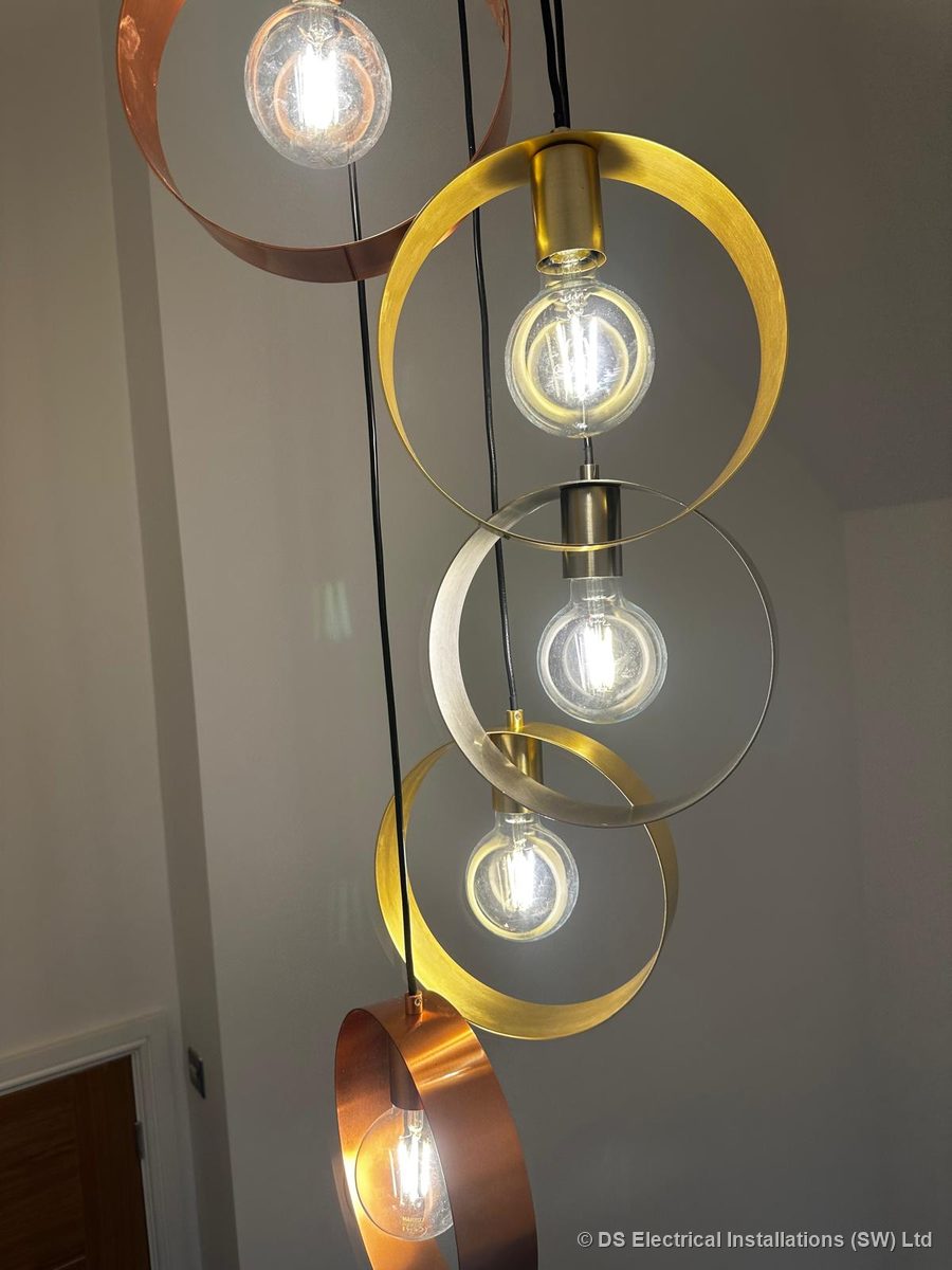 Five-drop brass, copper and nickel ring cluster pendant over a stairwell, installed by DS Electrical Installations (SW) Ltd