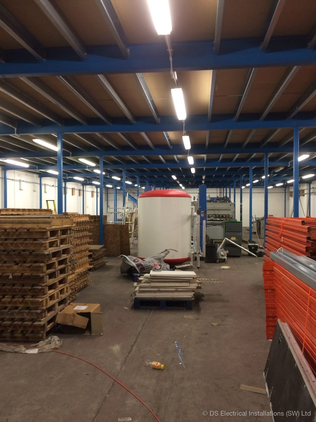 Warehouse LED lighting installation with pallet racking