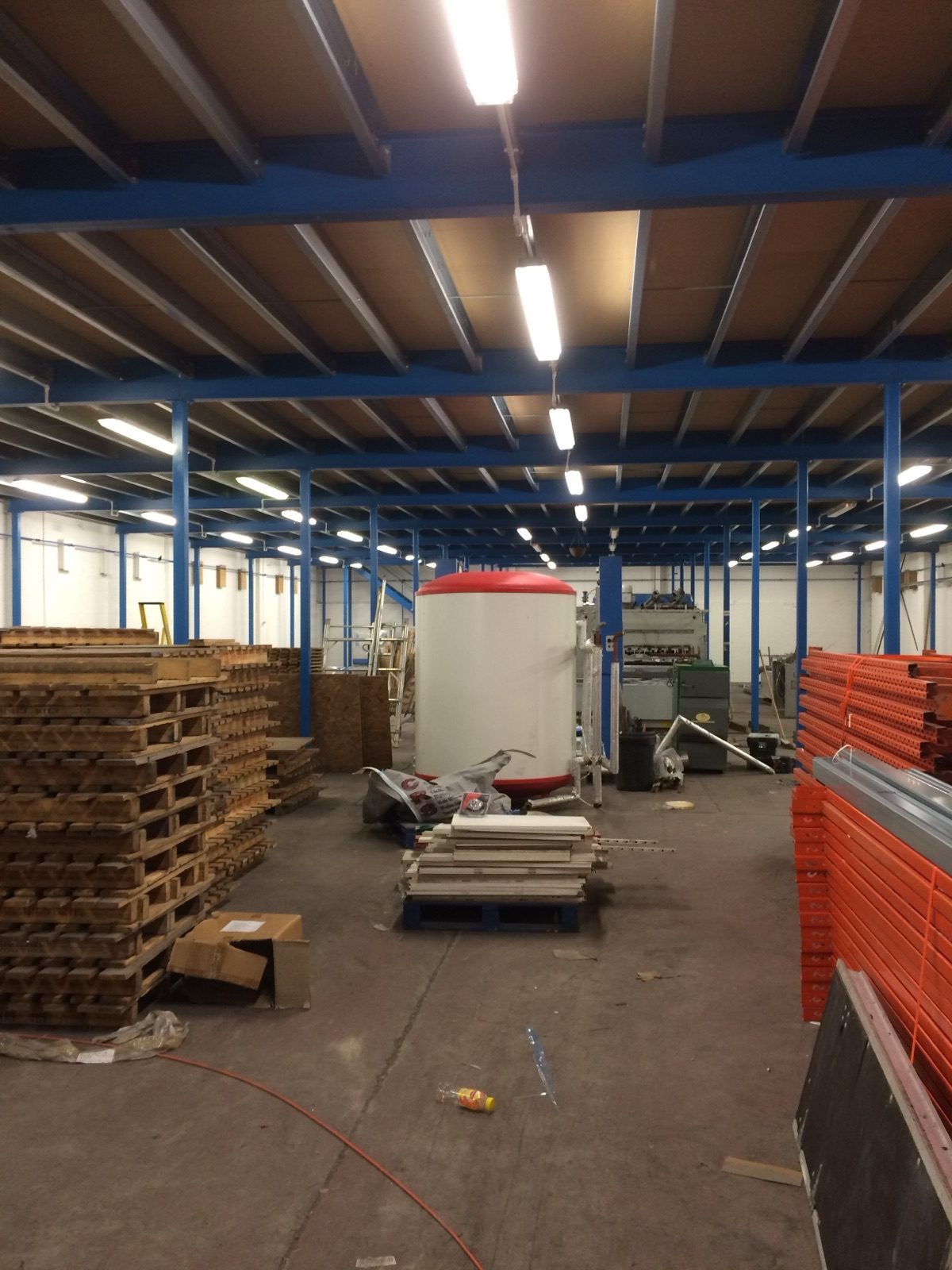 Warehouse LED lighting installation with pallet racking