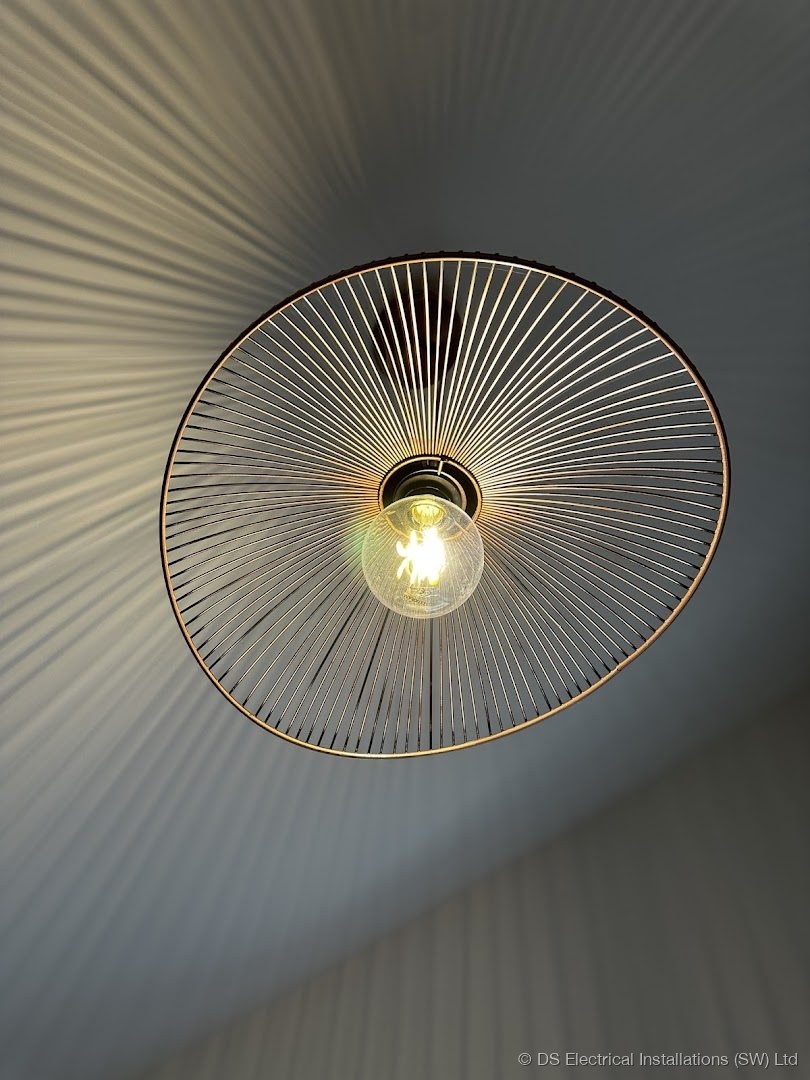 Designer wire sunburst pendant light installed and wired